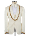 Light cream tuxedo jacket with gold stone-embellished trim, waistcoat, and bow tie