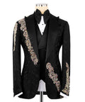 Black tuxedo jacket with black bow tie, white shirt, and jeweled gold/pink trim accents