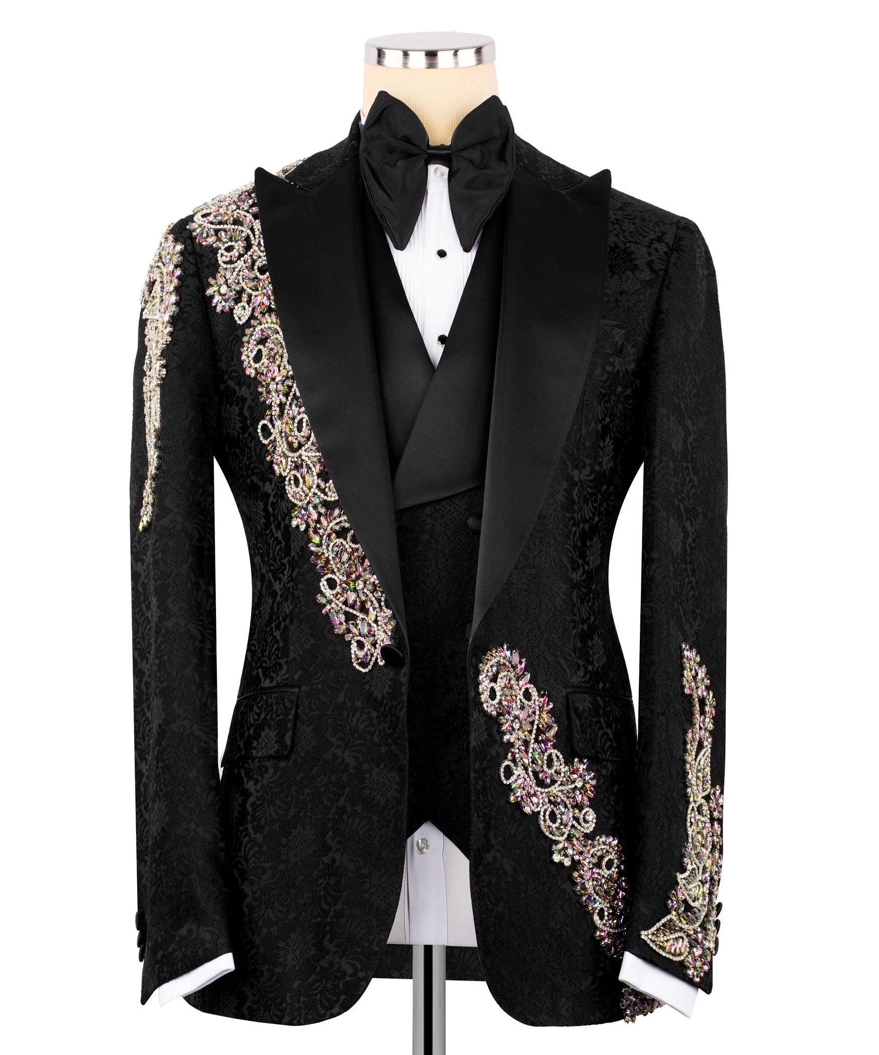 Black tuxedo jacket with black bow tie, white shirt, and jeweled gold/pink trim accents