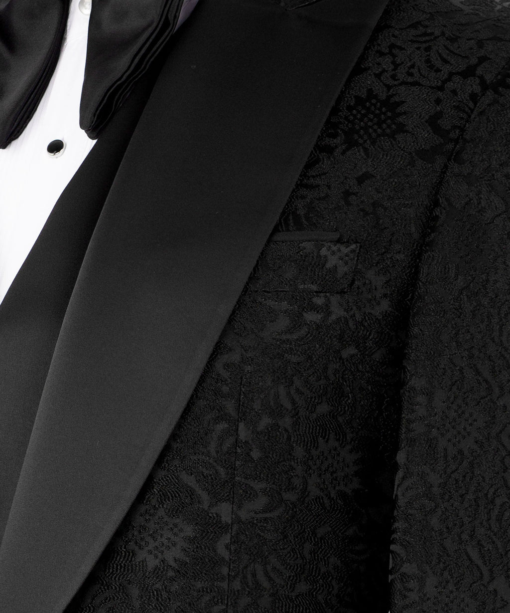 Black tuxedo jacket close-up showing textured fabric and lapel detail