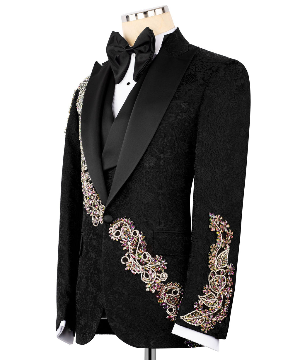 Black tuxedo jacket with jeweled trim on pocket and cuffs, satin lapels, black bow tie