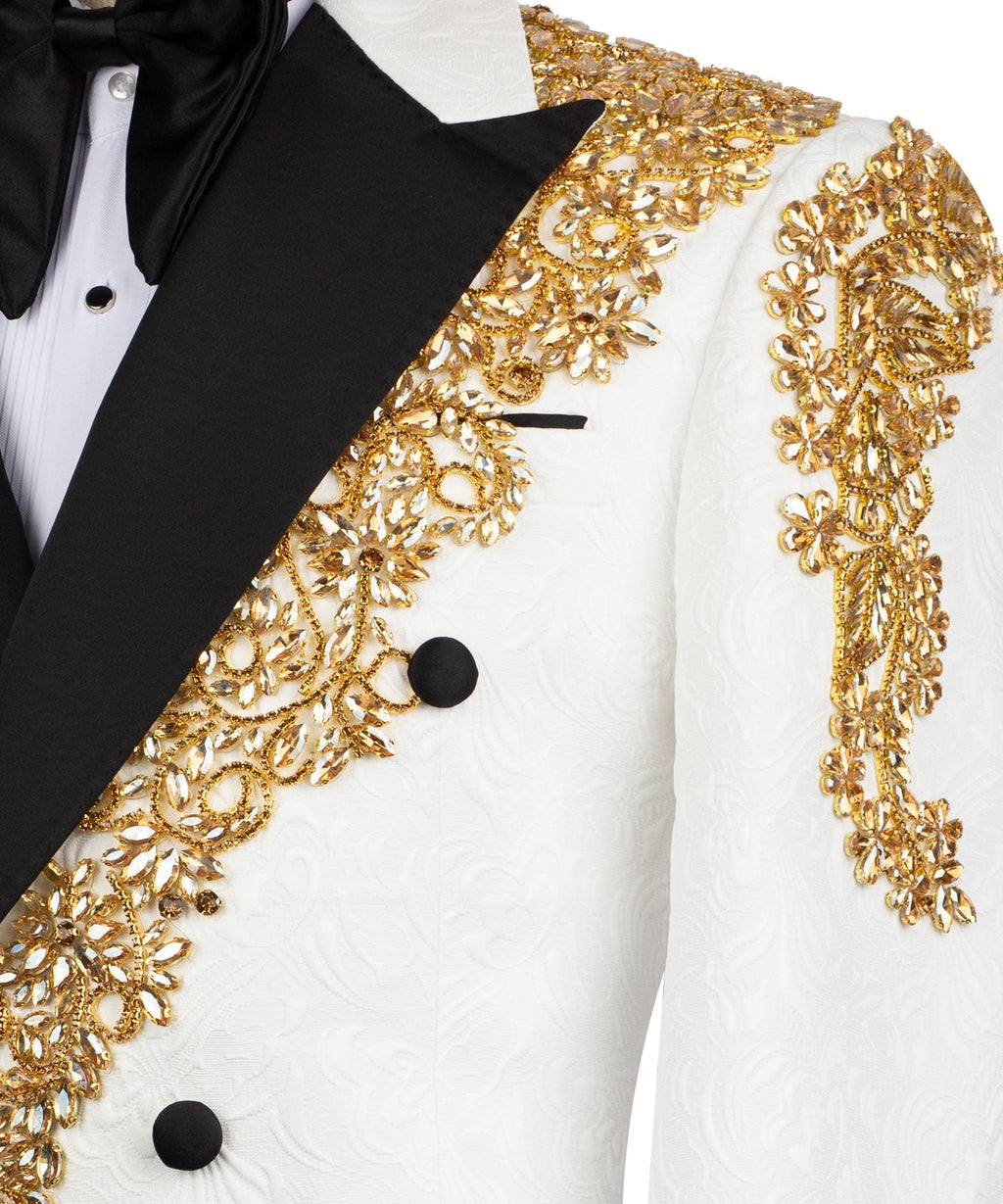 Close-up: gold stone-embroidered trim with black lapel on white textured tuxedo jacket