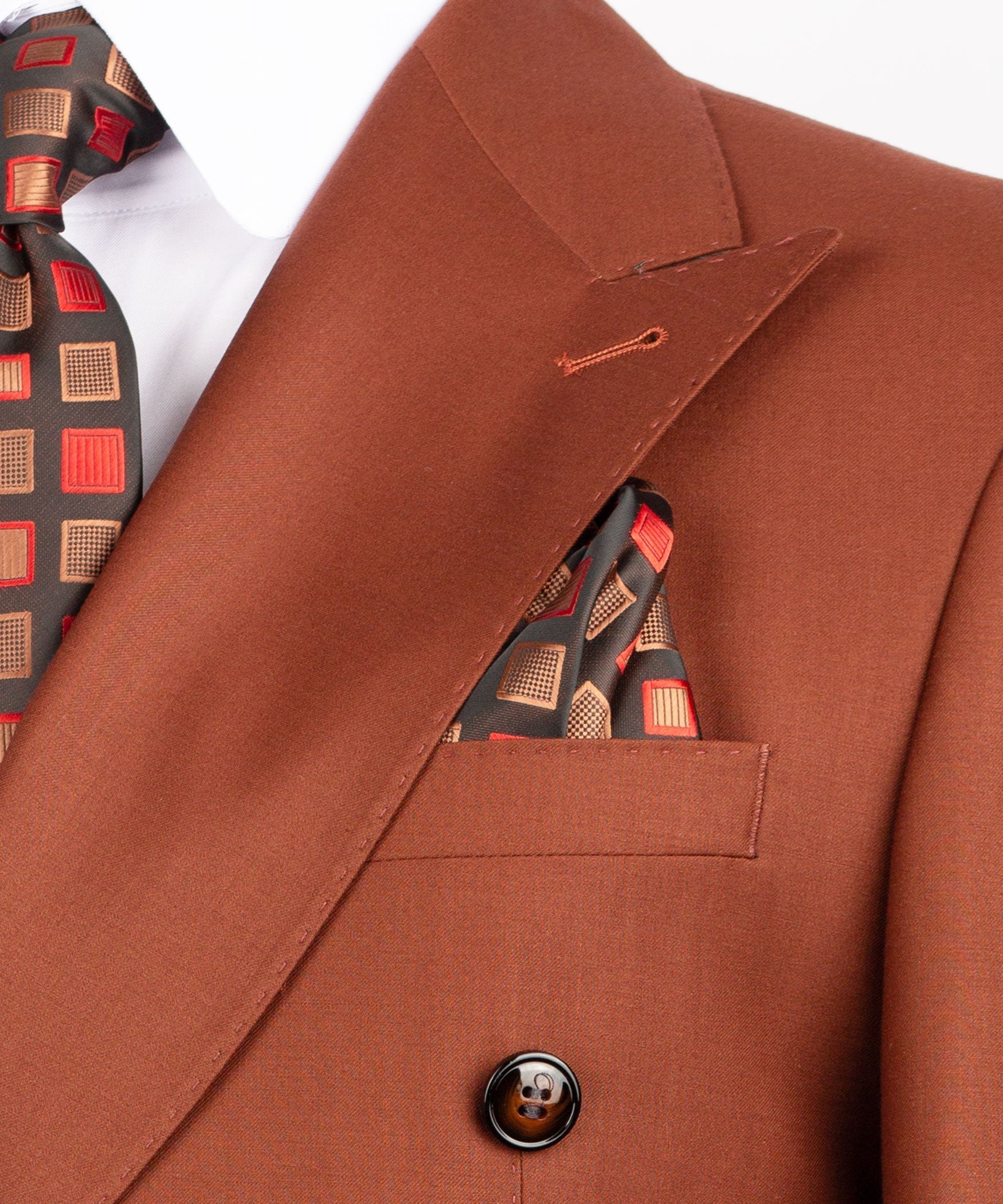 Close-up of rust-brown suit jacket lapel, flap pocket, and round button