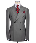 Grey double-breasted suit jacket with notched lapels, black buttons, and red patterned tie