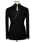 Black tuxedo jacket with stone embroidery, satin lapels, bow tie, and white shirt