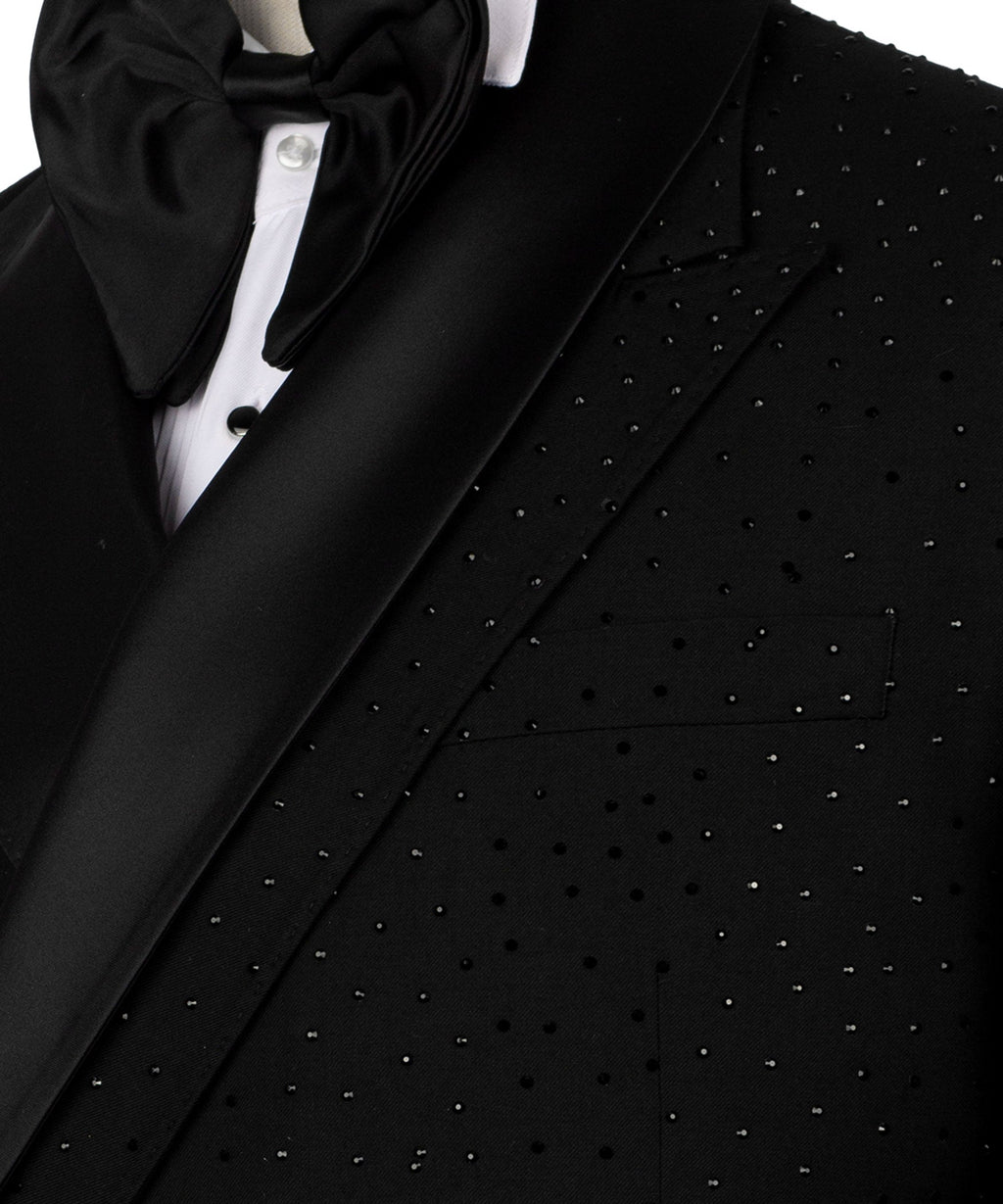 Close-up: black tuxedo lapel and bow tie with stone-like beaded embroidery