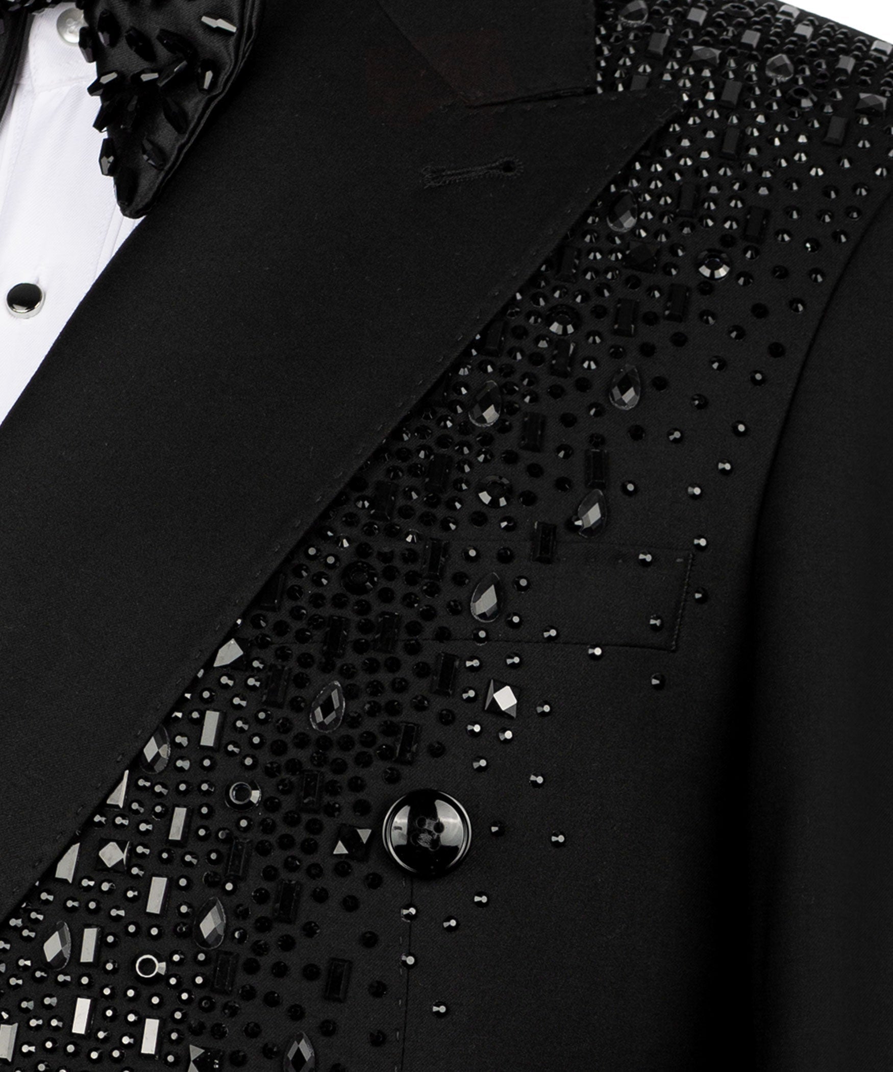 Close-up: black tuxedo blazer embroidery details with dark button on lapel