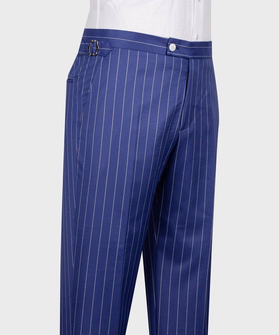 Blue pinstripe trousers with thin white vertical stripes, featuring a belt loop and button closure, shown on a model wearing a white shirt against a light gray background.