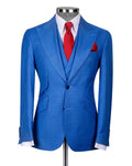 A men's blue textured two-piece suit displayed on a mannequin, styled with a white dress shirt, a red tie, and a matching red pocket square against a light gray background.