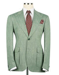 Green suit jacket with a red patterned tie and pocket square on a mannequin against a white background