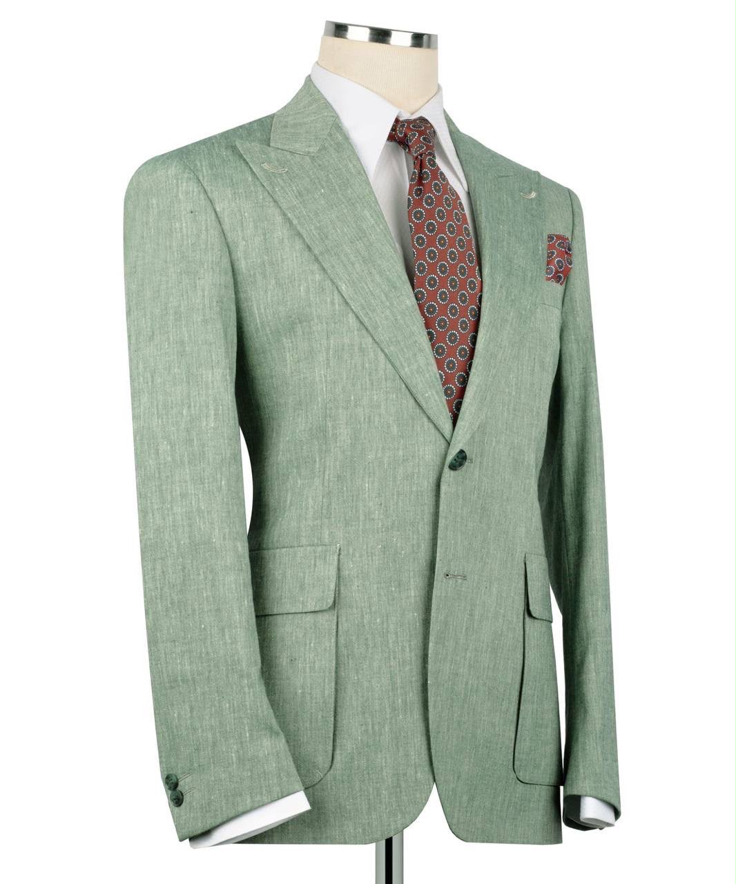 A light sage green textured suit jacket displayed on a mannequin torso, styled with a white dress shirt, a red and blue patterned tie, and a matching pocket square against a white background.