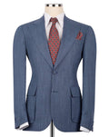A blue pinstripe suit jacket displayed on a mannequin torso, styled with a white dress shirt, a red and blue patterned tie, and a matching pocket square against a plain white background.