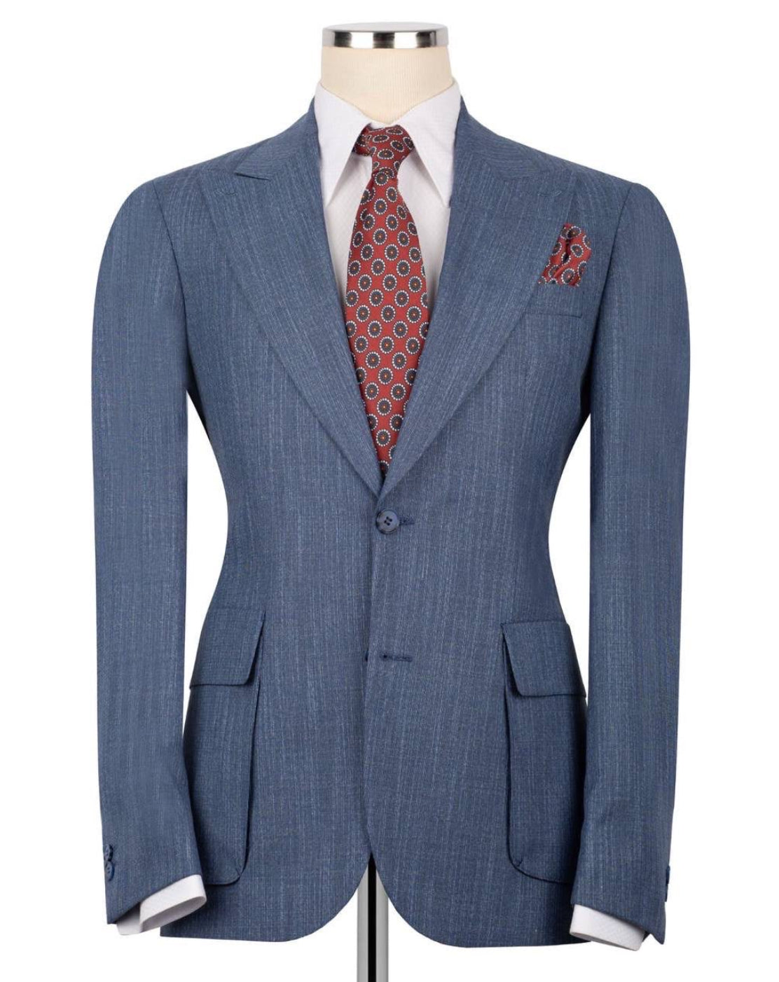 A blue pinstripe suit jacket displayed on a mannequin torso, styled with a white dress shirt, a red and blue patterned tie, and a matching pocket square against a plain white background.