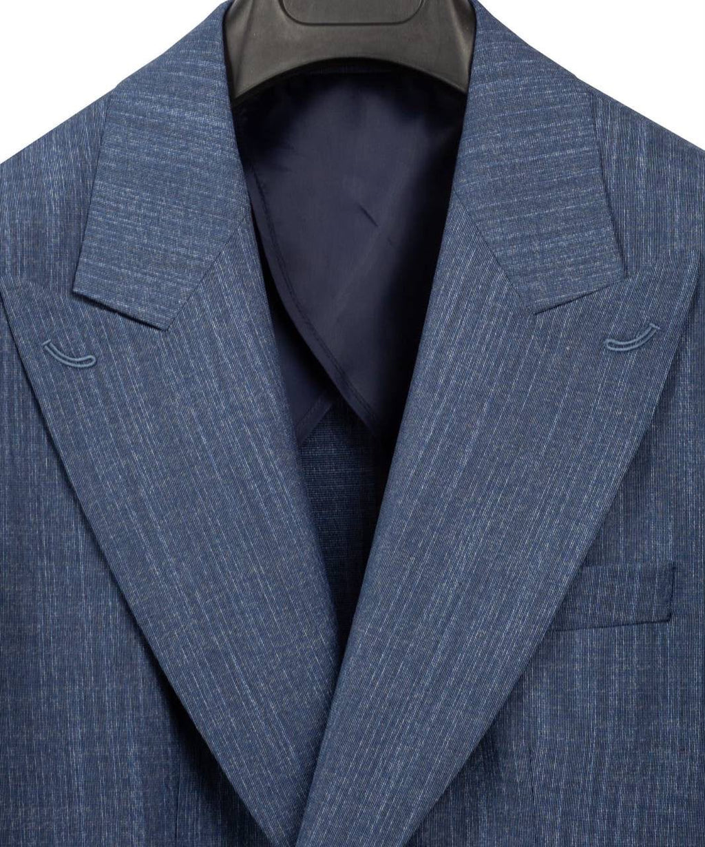 A close-up of a blue pinstriped suit jacket hanging on a black hanger, showing the textured fabric, notch lapels, and a dark navy inner lining.
