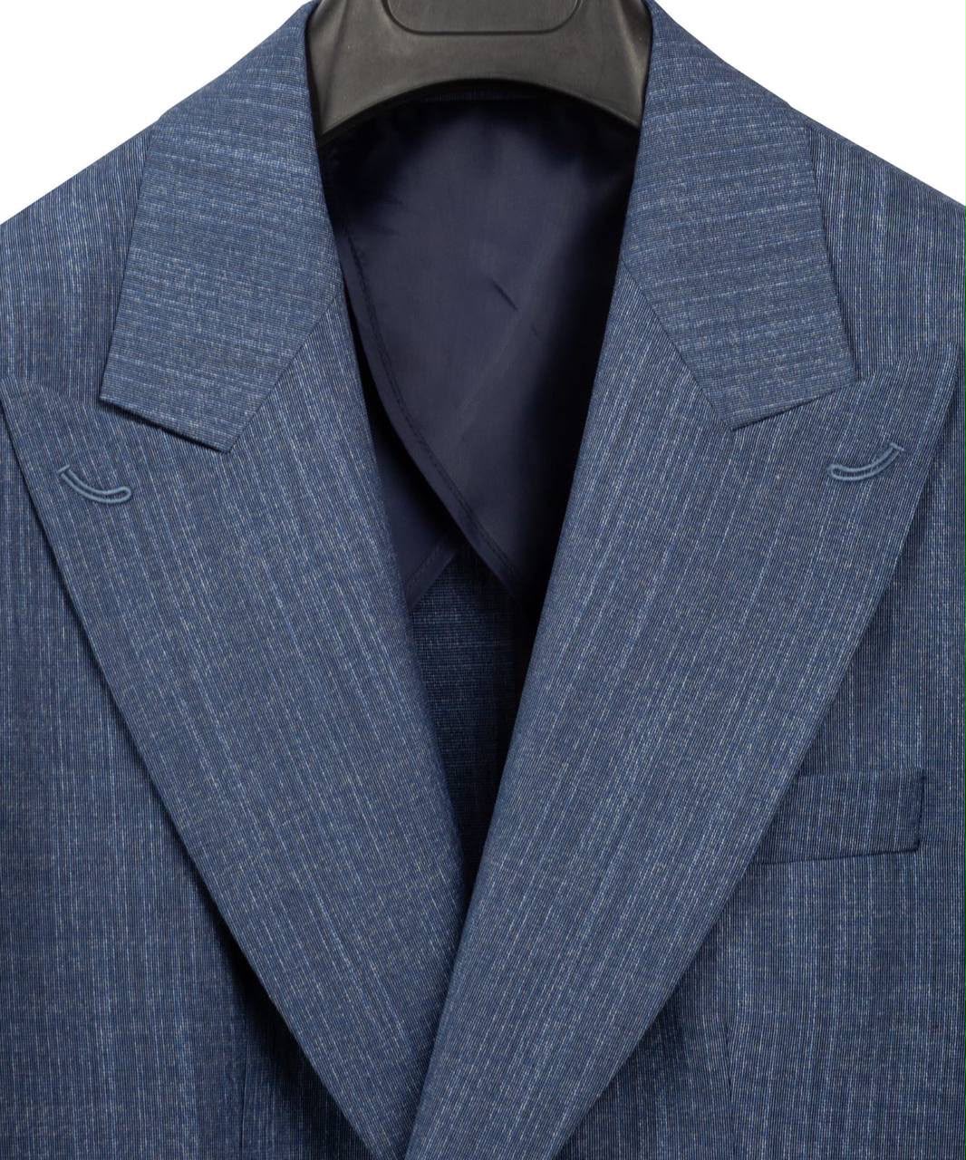 A close-up of a blue pinstriped suit jacket hanging on a black hanger, showing the textured fabric, notch lapels, and a dark navy inner lining.