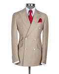 A beige double-breasted suit jacket displayed on a mannequin torso, styled with a white dress shirt, a red patterned tie, and a matching red pocket square 