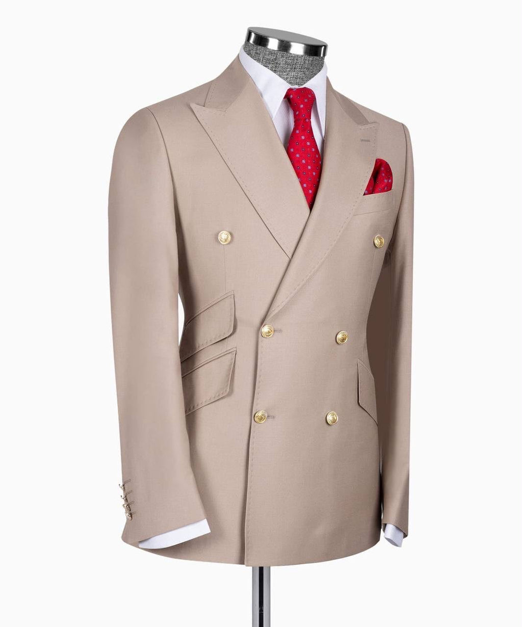 A beige double-breasted suit jacket displayed on a mannequin torso, styled with a white dress shirt, a red patterned tie, and a matching red pocket square 