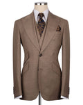 Brown suit jacket on a mannequin with a white shirt, patterned tie, and pocket square.
