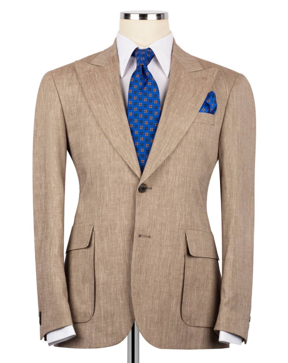 A men's light tan textured suit jacket displayed on a mannequin torso, styled with a white dress shirt, a blue patterned tie, and a matching blue pocket square against a plain white background.