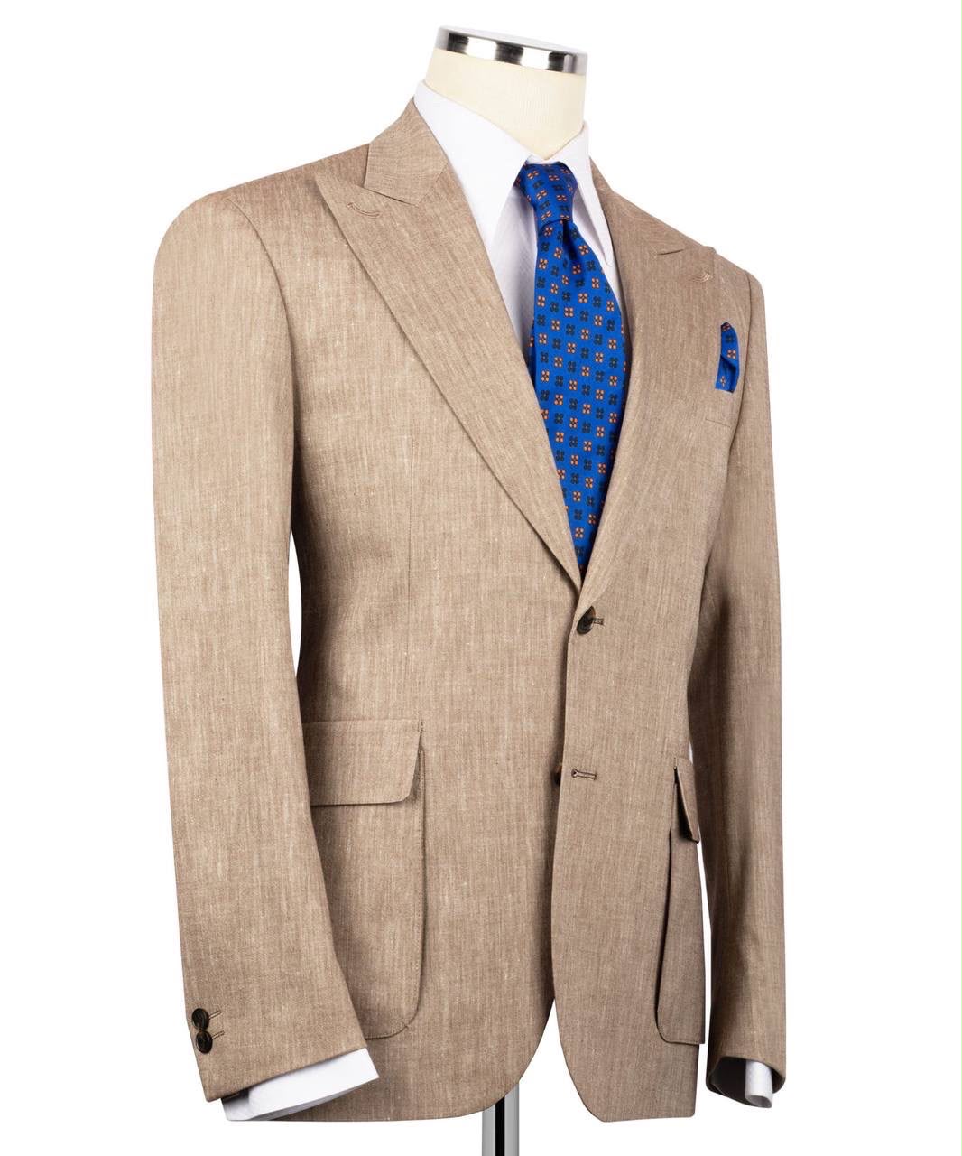 Beige suit jacket with a blue patterned tie on a mannequin against a white background