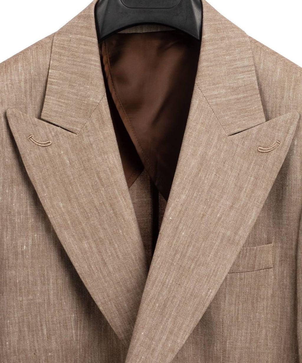 A close-up of a men's blazer in a textured beige linen-like fabric, featuring notched lapels, a chest pocket, and a dark brown satin inner lining, shown on a black hanger against a white background.
