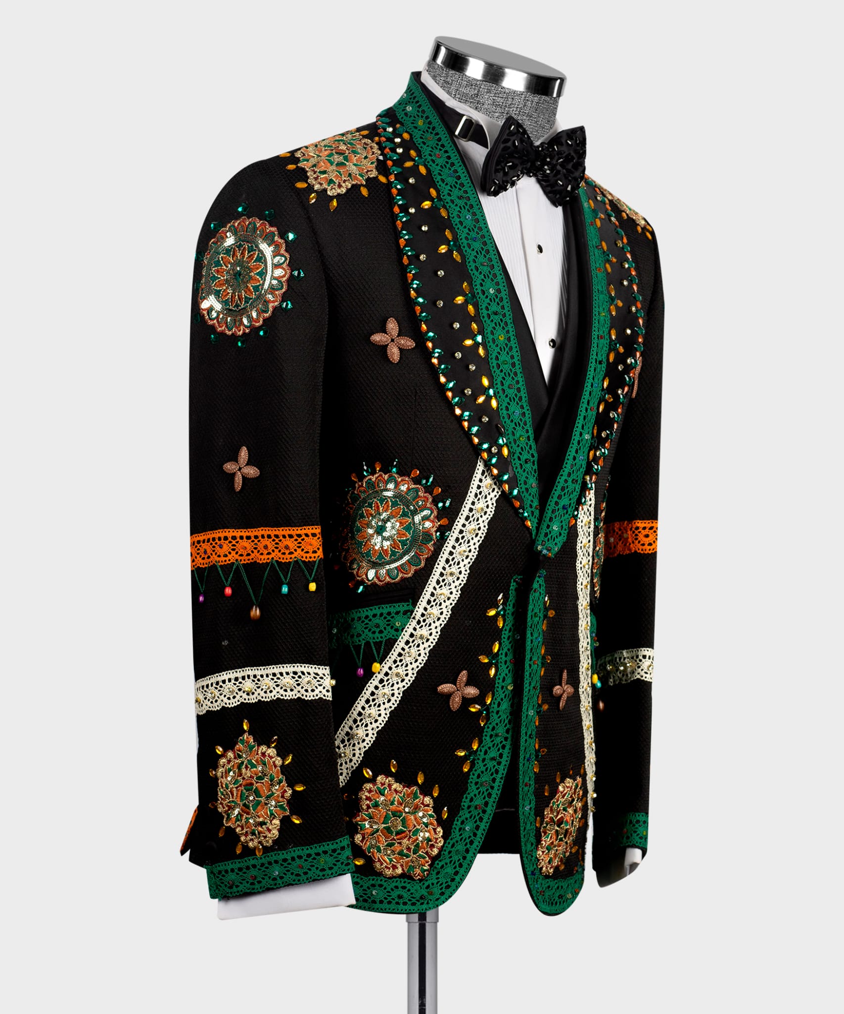 Black tuxedo jacket with green trim, butterfly motifs, and crystal-style embellishments