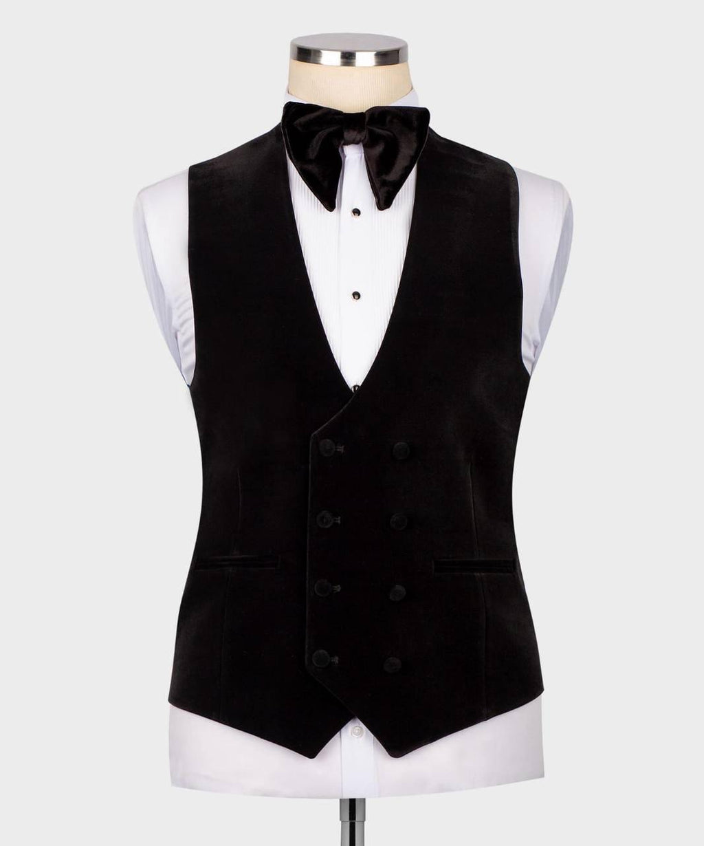 A black double-breasted velvet tuxedo vest displayed on a white dress shirt and bow tie mannequin against a light gray background.
