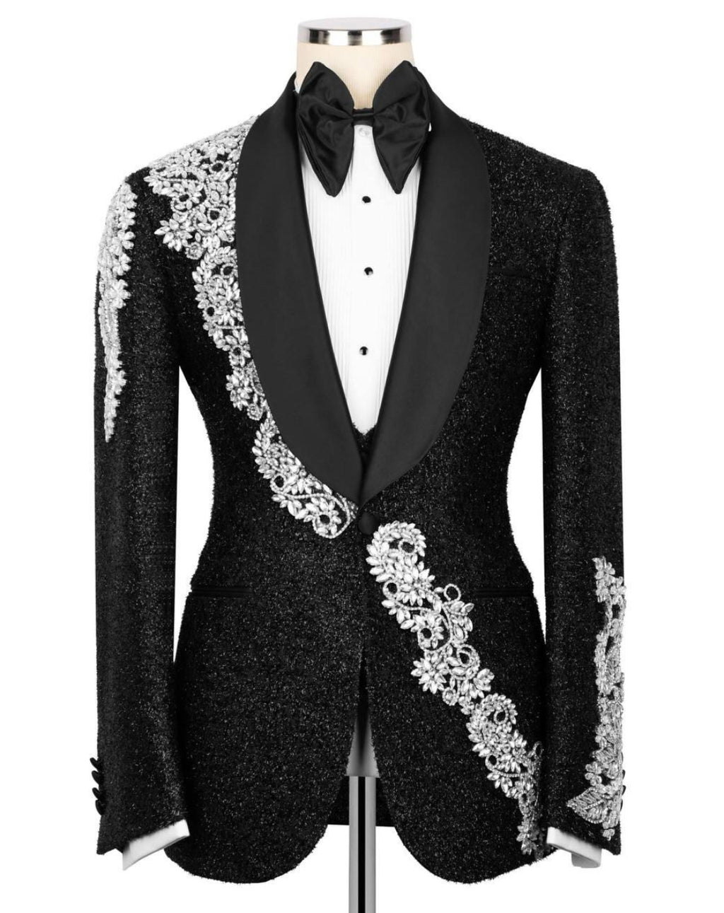Black tuxedo with white embroidery on a mannequin against a white background