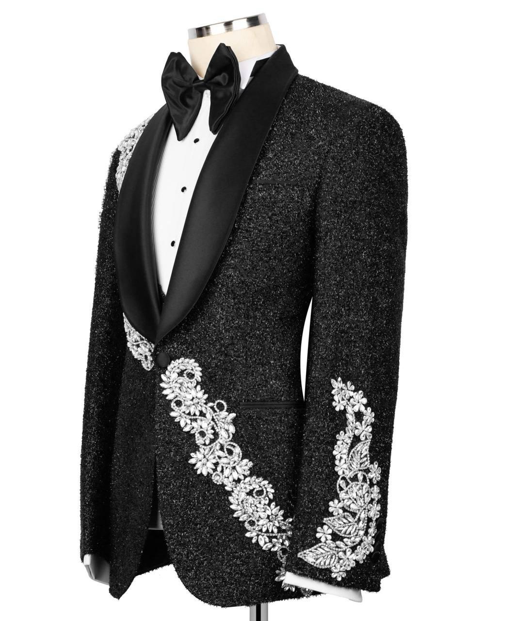 Black tuxedo with white embroidery on a mannequin against a white background