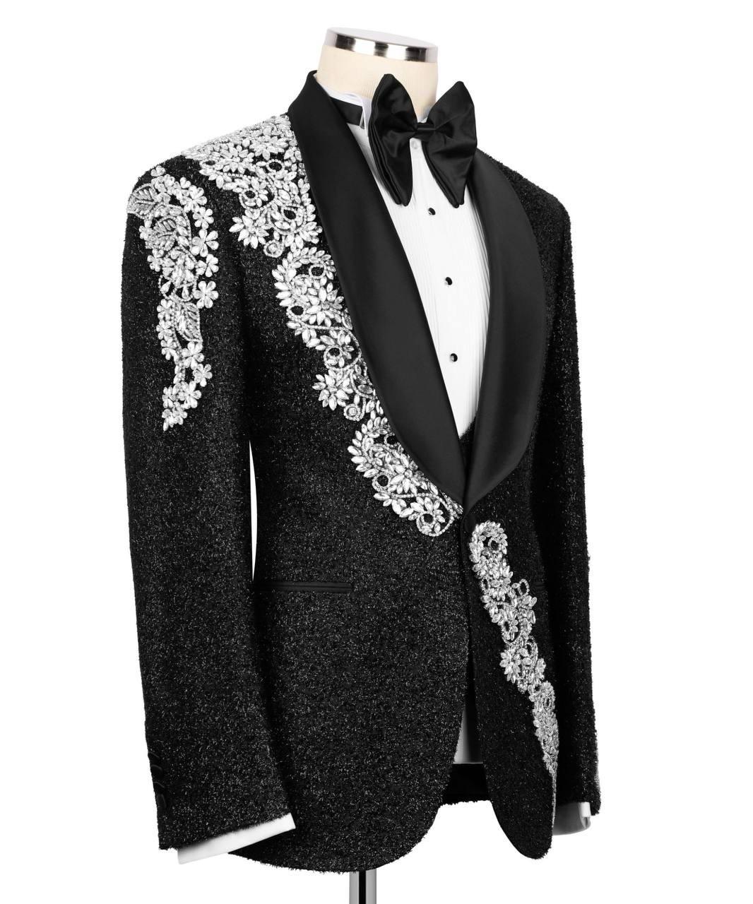 Black tuxedo with white lace detailing on a mannequin against a white background