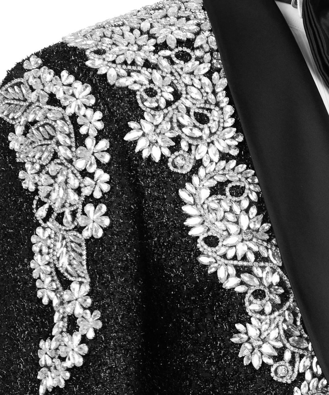 Close-up of a black fabric with silver floral embroidery