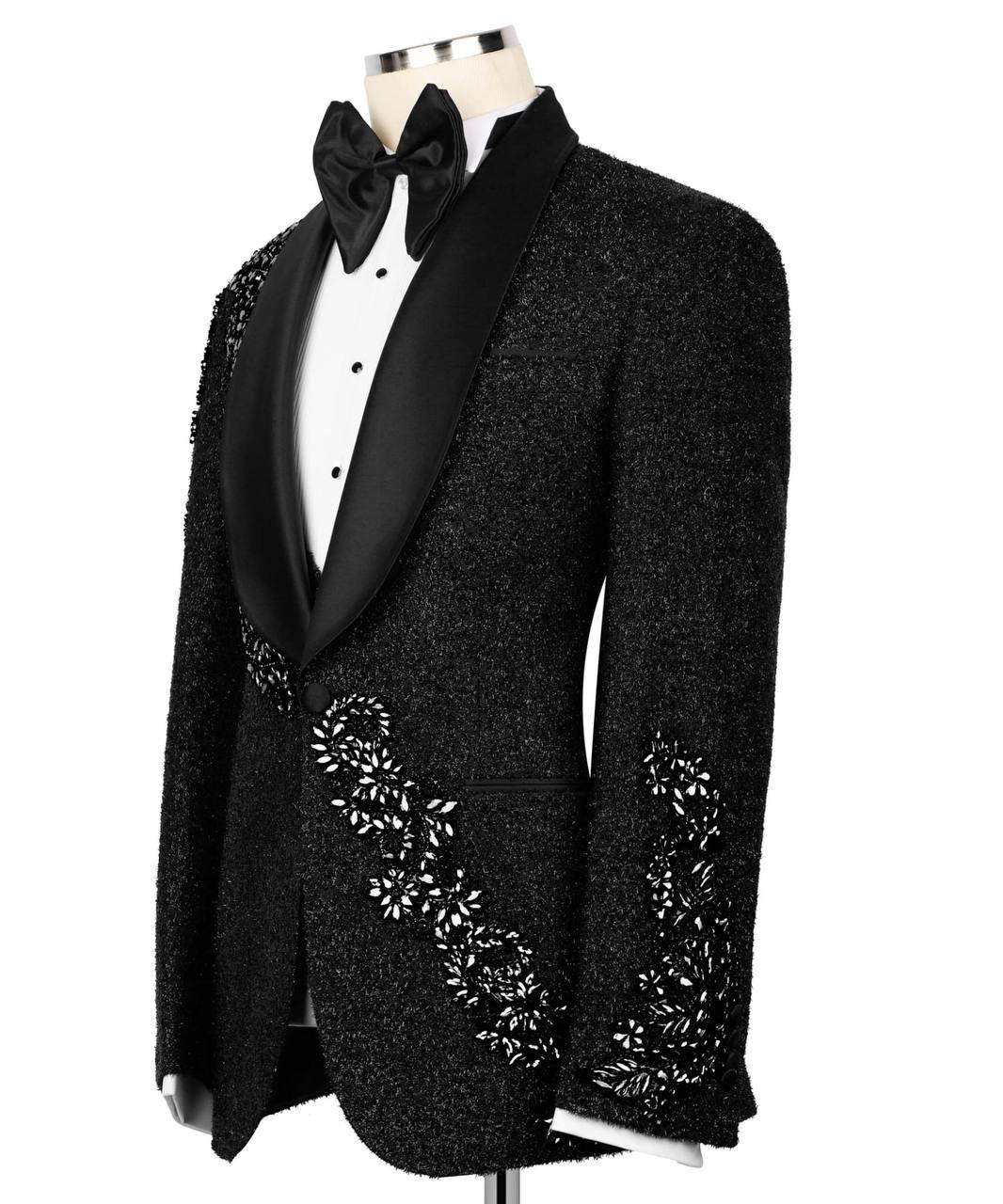 Black tuxedo with floral embroidery on a white background