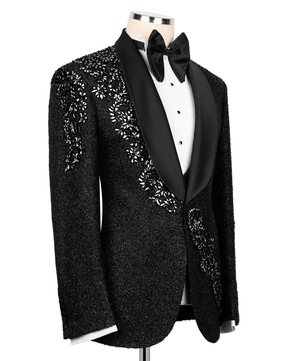 Black tuxedo with floral embroidery on a mannequin against a white background