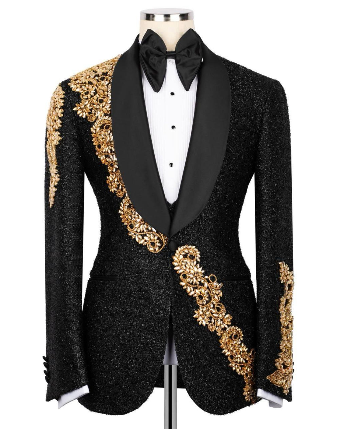 Black tuxedo with gold embroidery on a mannequin against a white background