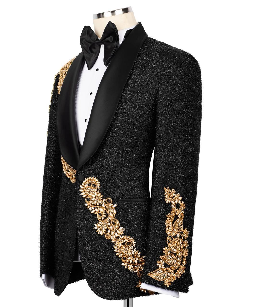 Black tuxedo with gold embroidery on a mannequin against a white background