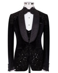 A black velvet tuxedo jacket with ornate beaded and sequined lapels and front panels, displayed on a mannequin with a white dress shirt, black vest, and matching bow tie 