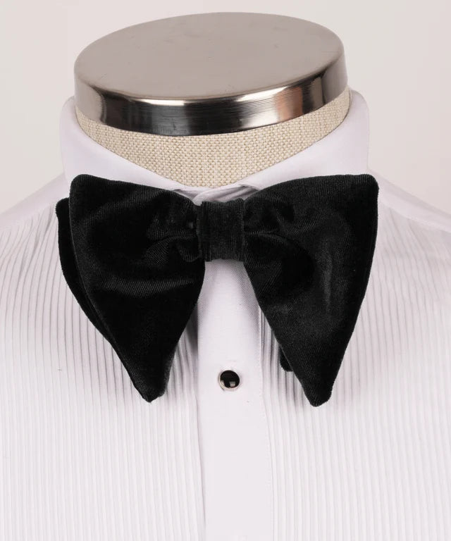 Black bow tie on a white shirt with a neutral background