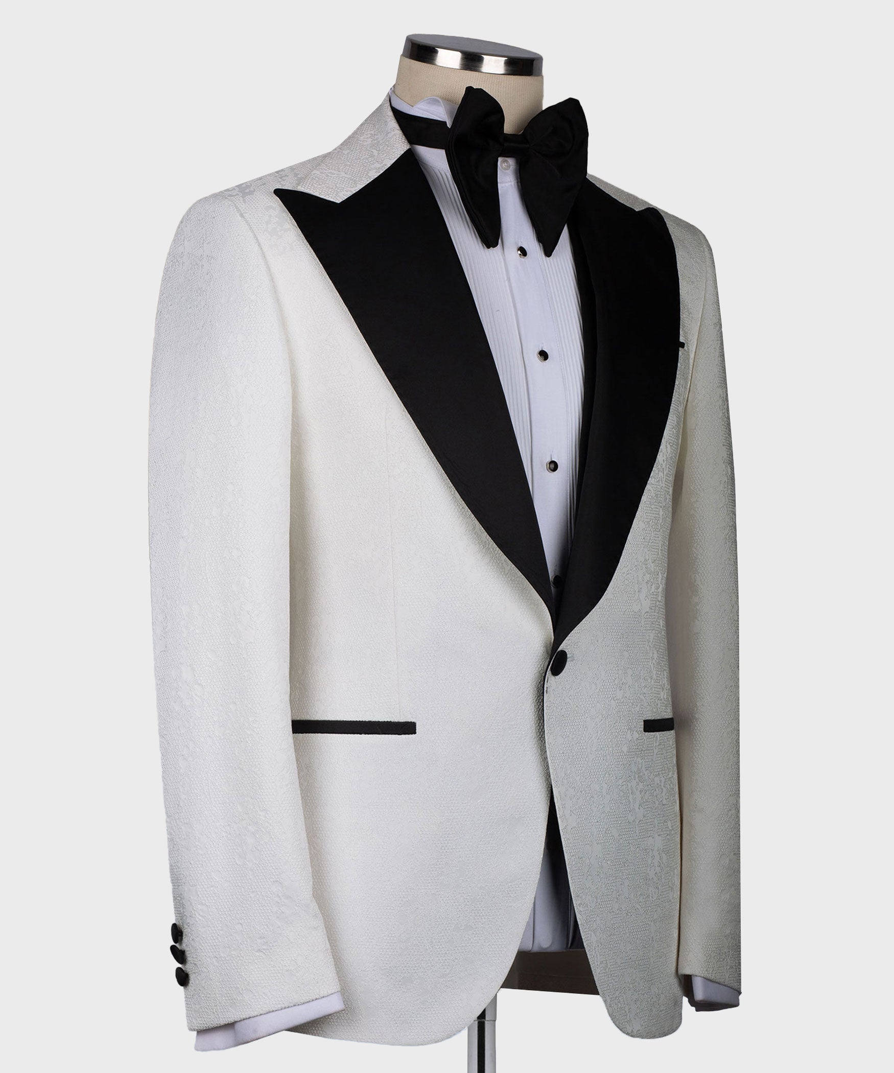 White tuxedo jacket with black shawl-style lapel and bow tie, formal front view