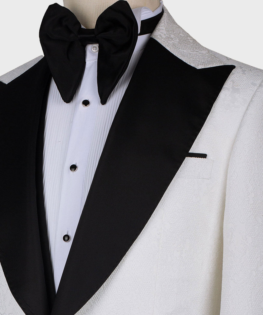 Close-up of black bow tie, white dress shirt, and black satin lapel on tuxedo jacket