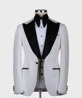 White tuxedo jacket with black satin lapels, pointed collar, and bow tie