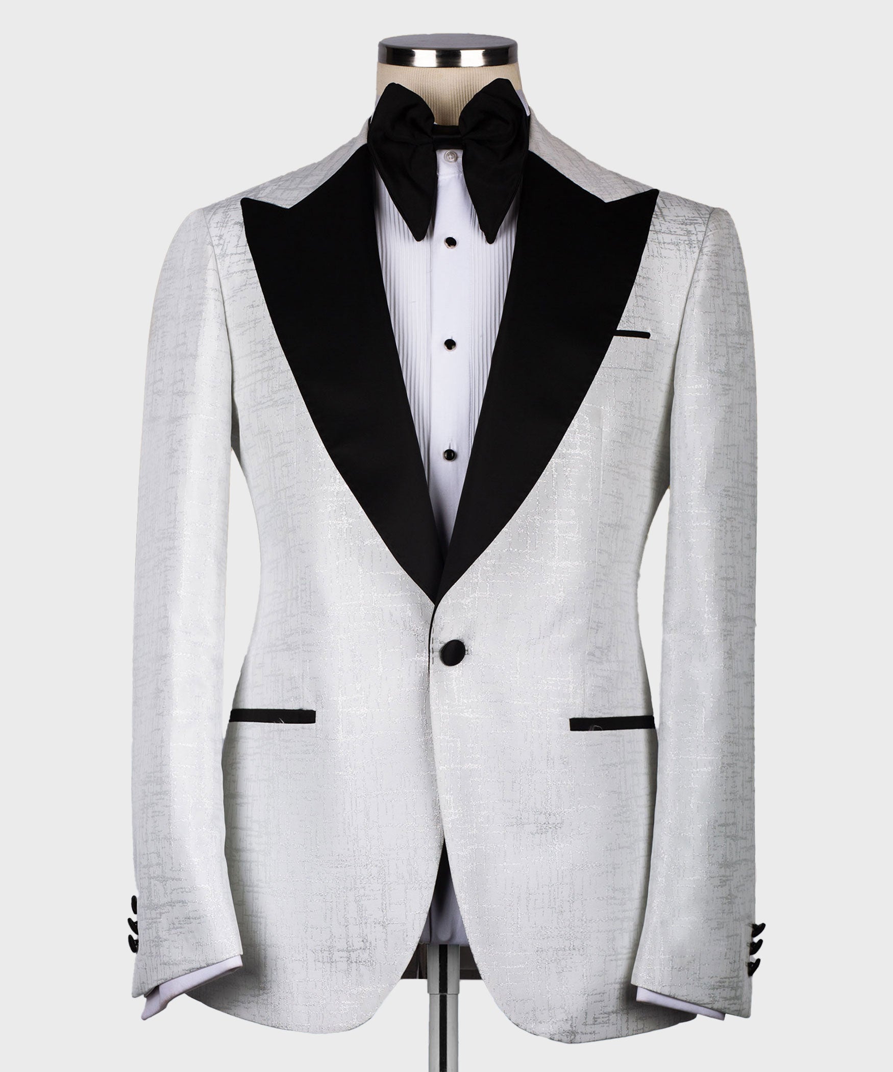 Light gray tuxedo jacket with single-button closure, black lapels, and bow tie