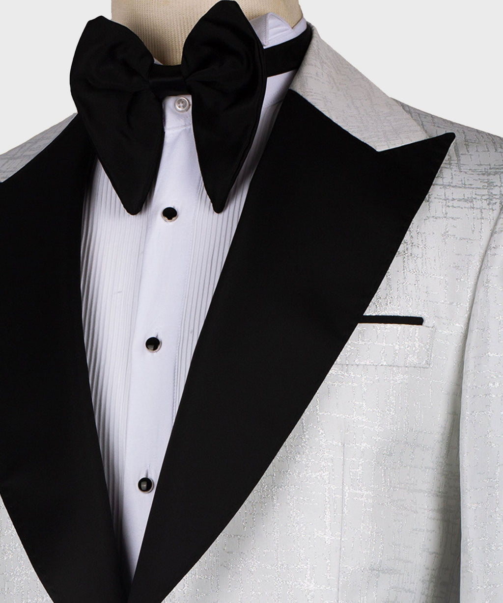 Black bow tie and pointed black lapel over white pleated dress shirt