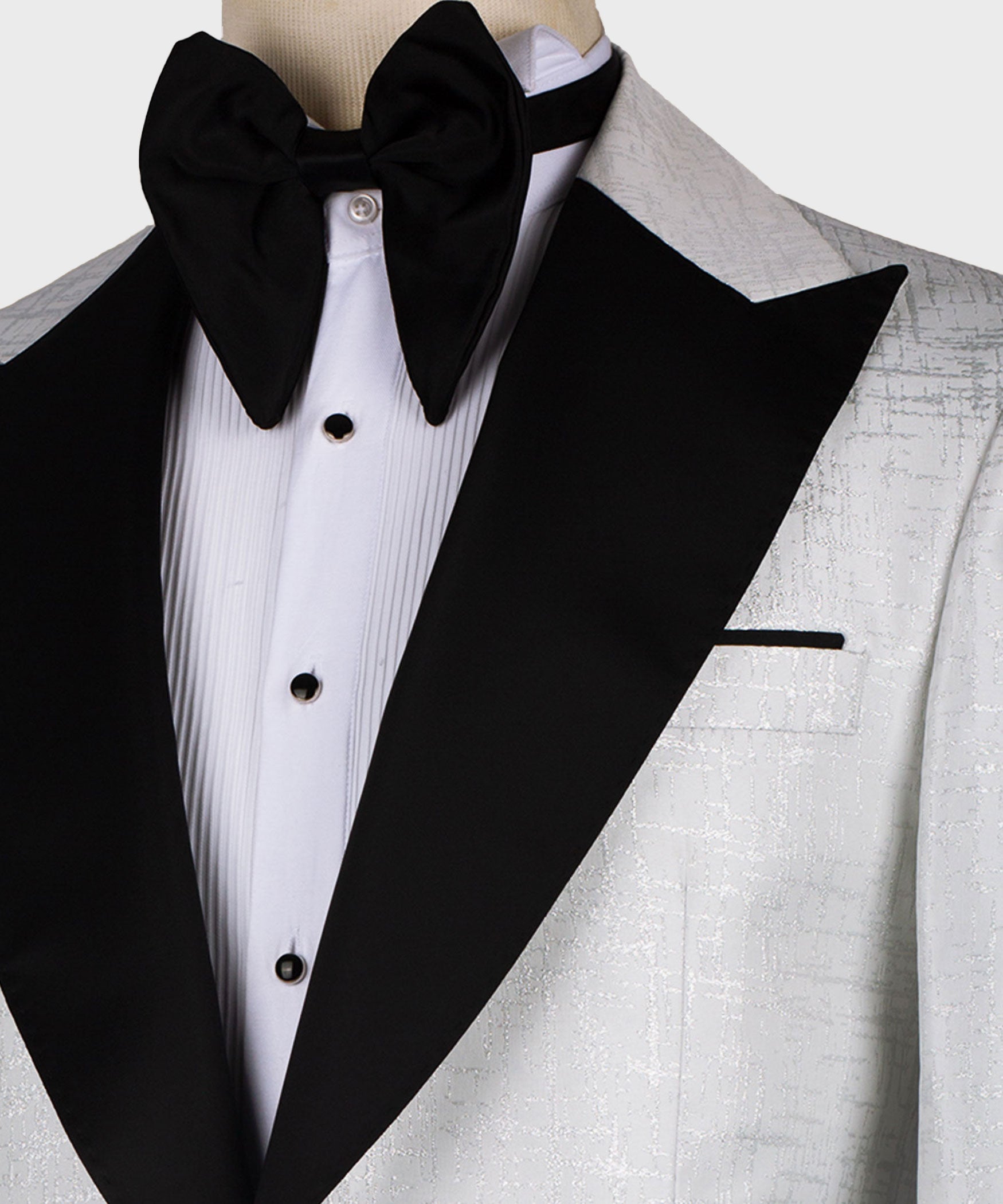 Black bow tie and pointed black lapel over white pleated dress shirt