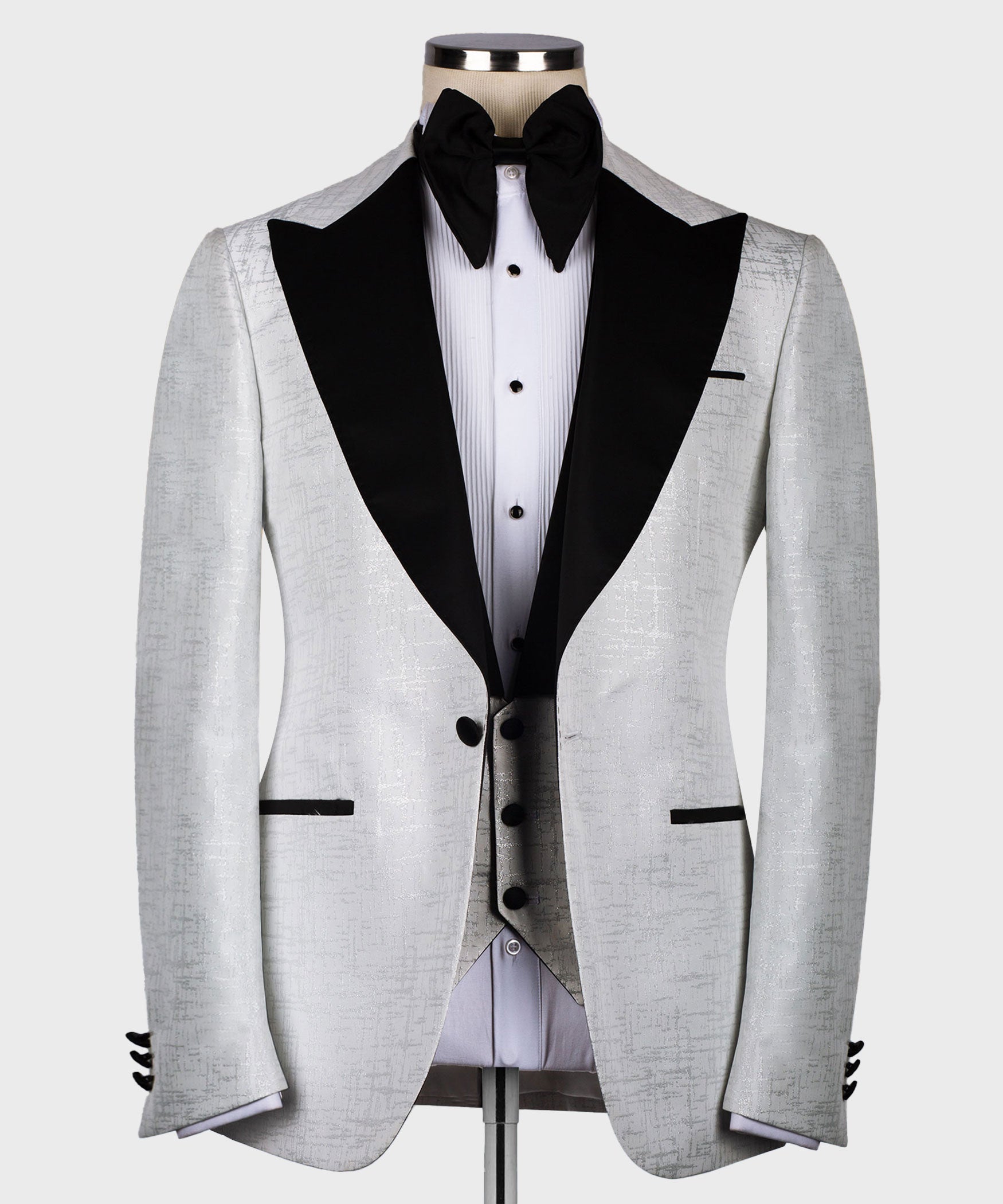 Light gray tuxedo jacket with pointed black satin lapels and black bow tie