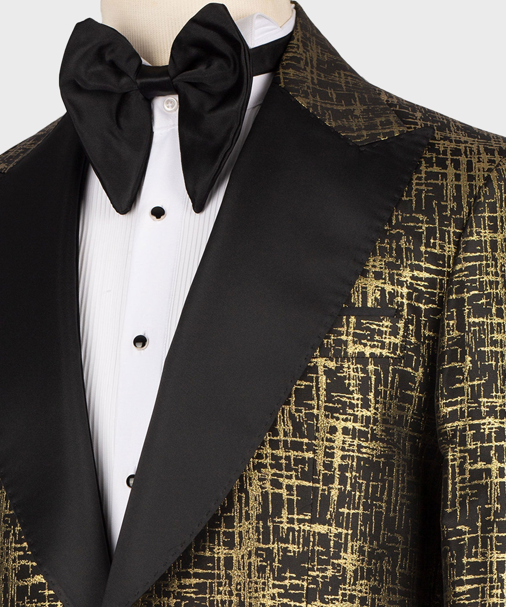 Black satin bow tie and pointed collar shirt with gold patterned tuxedo lapel