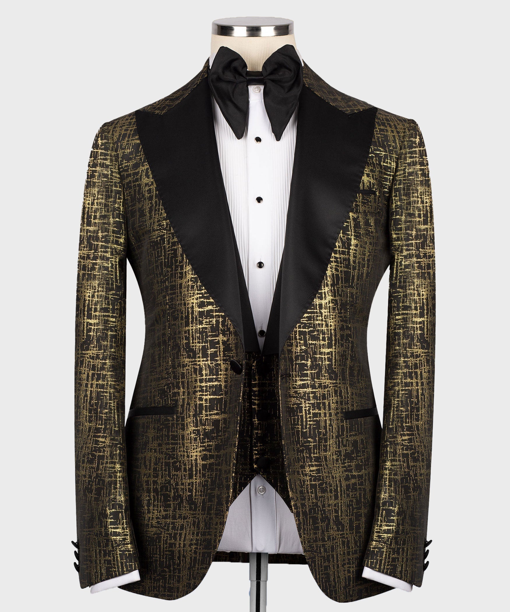 Gold textured tuxedo jacket with black satin lapels, white dress shirt, black bow tie