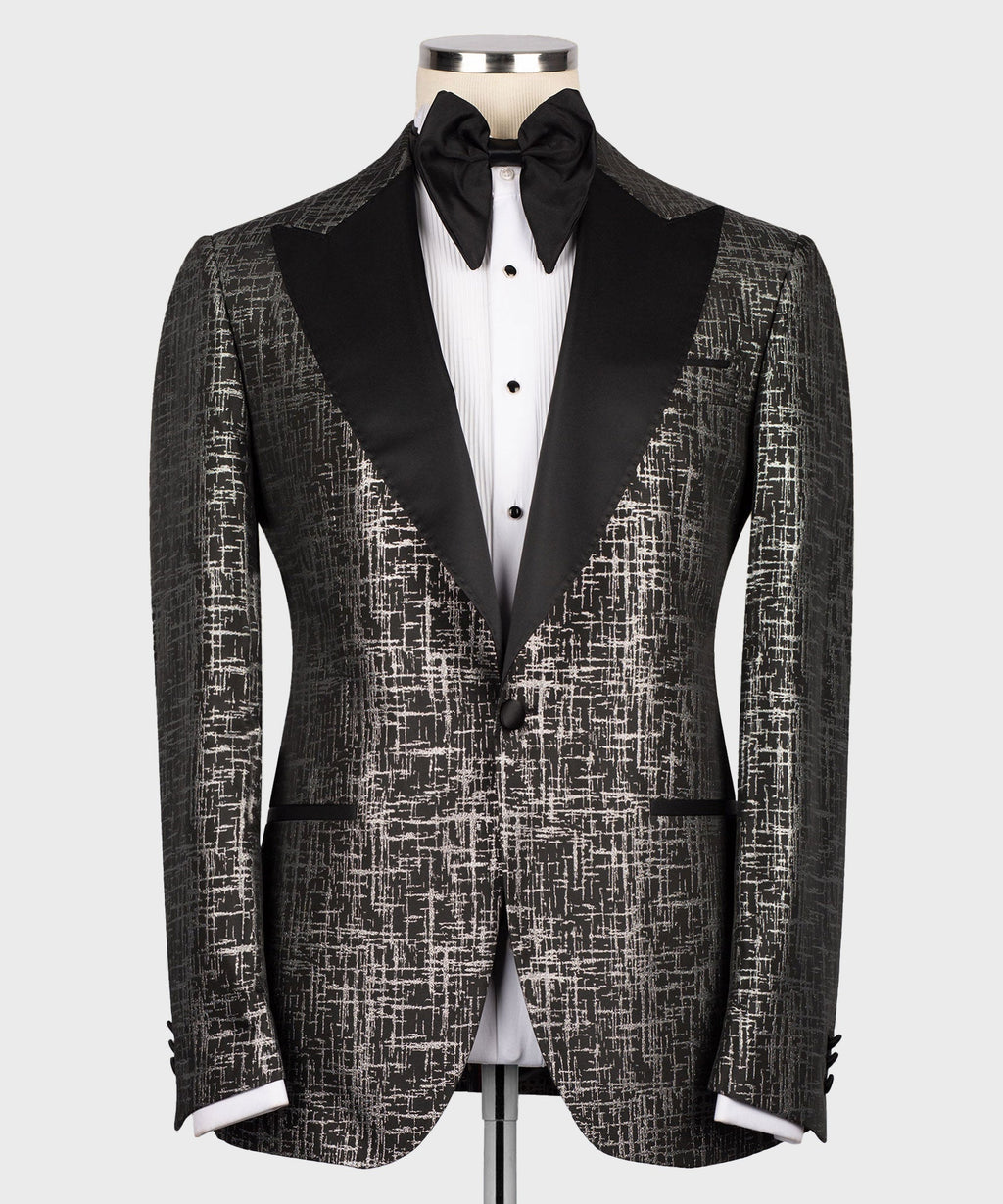 Front view tuxedo set with patterned jacket, satin pointed lapels, black bow tie and vest