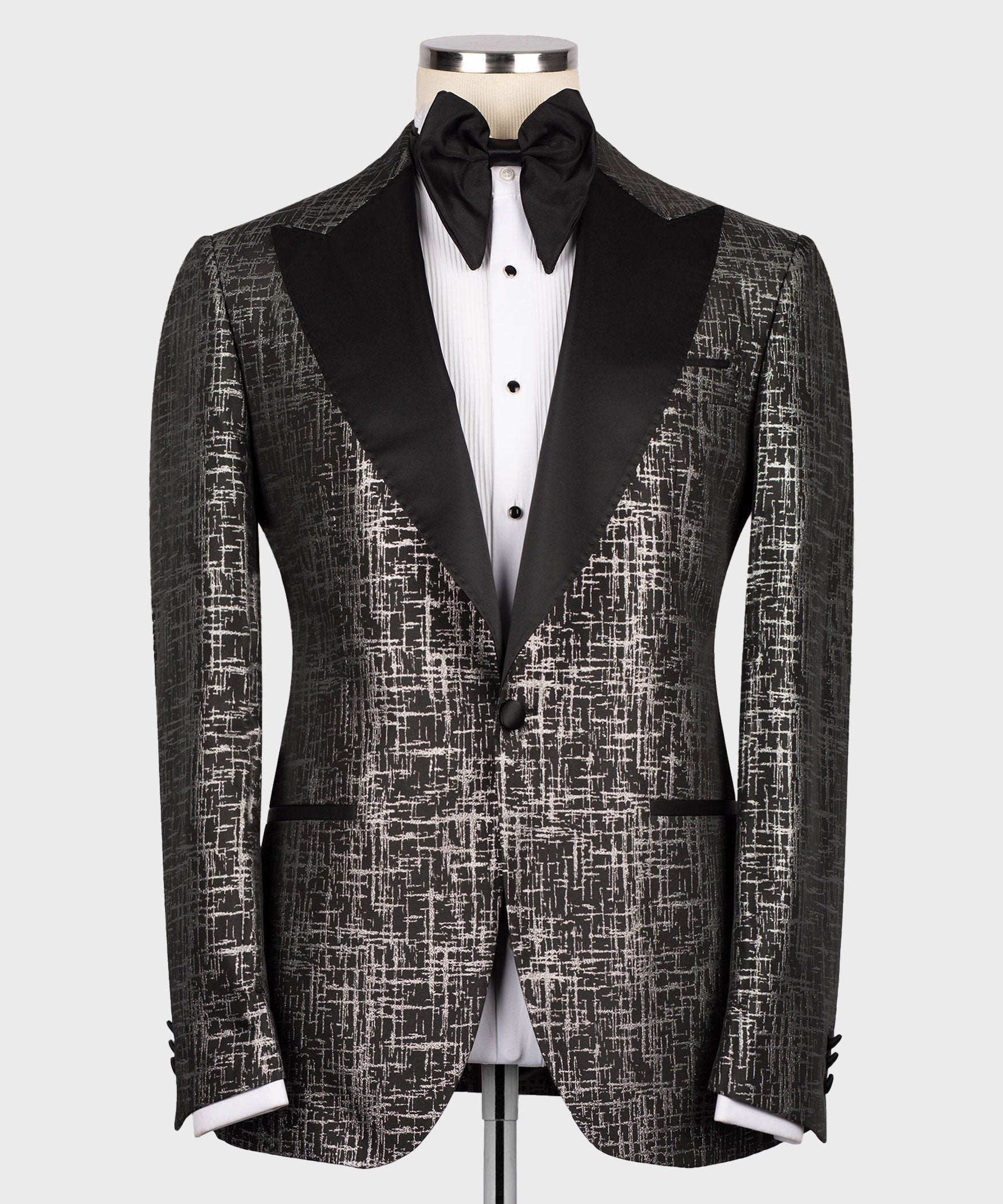Front view tuxedo set with patterned jacket, satin pointed lapels, black bow tie and vest