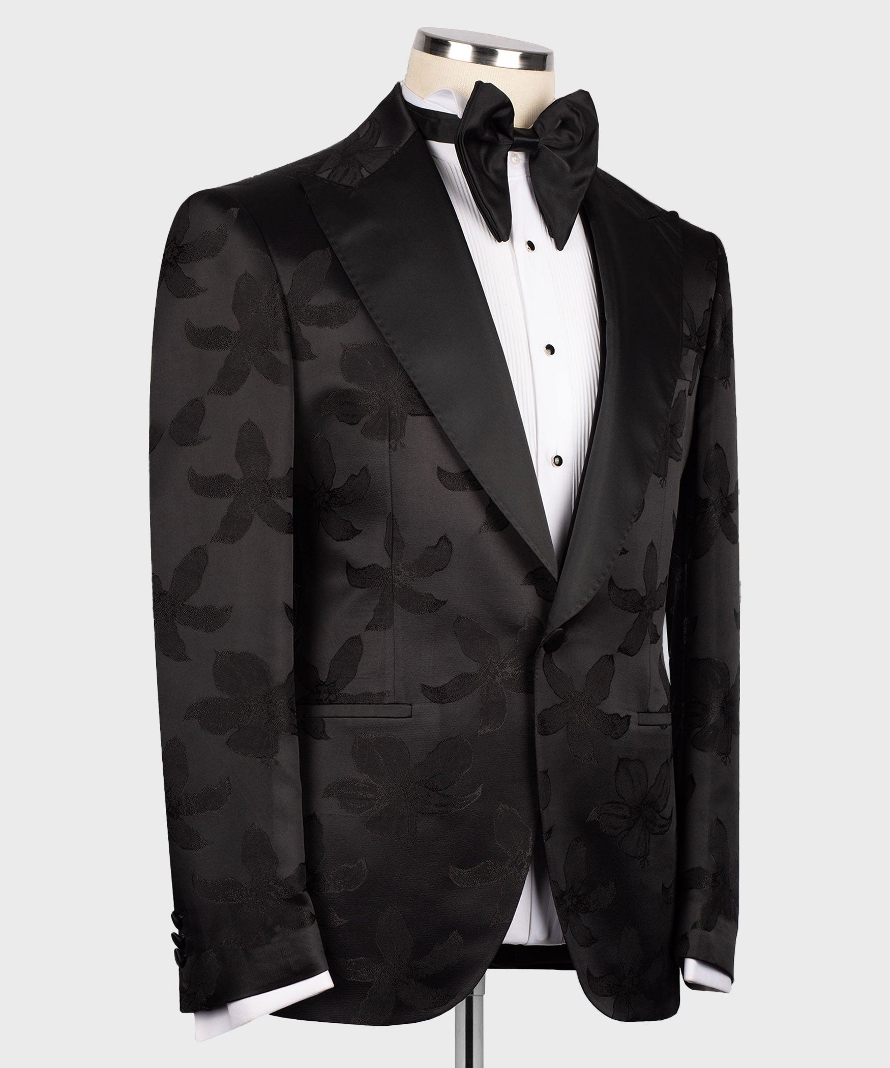 Black tuxedo jacket and vest set with satin lapels, bow tie, and subtle floral pattern