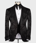 Black pointed-collar tuxedo set with bow tie, floral jacquard jacket, and buttoned vest